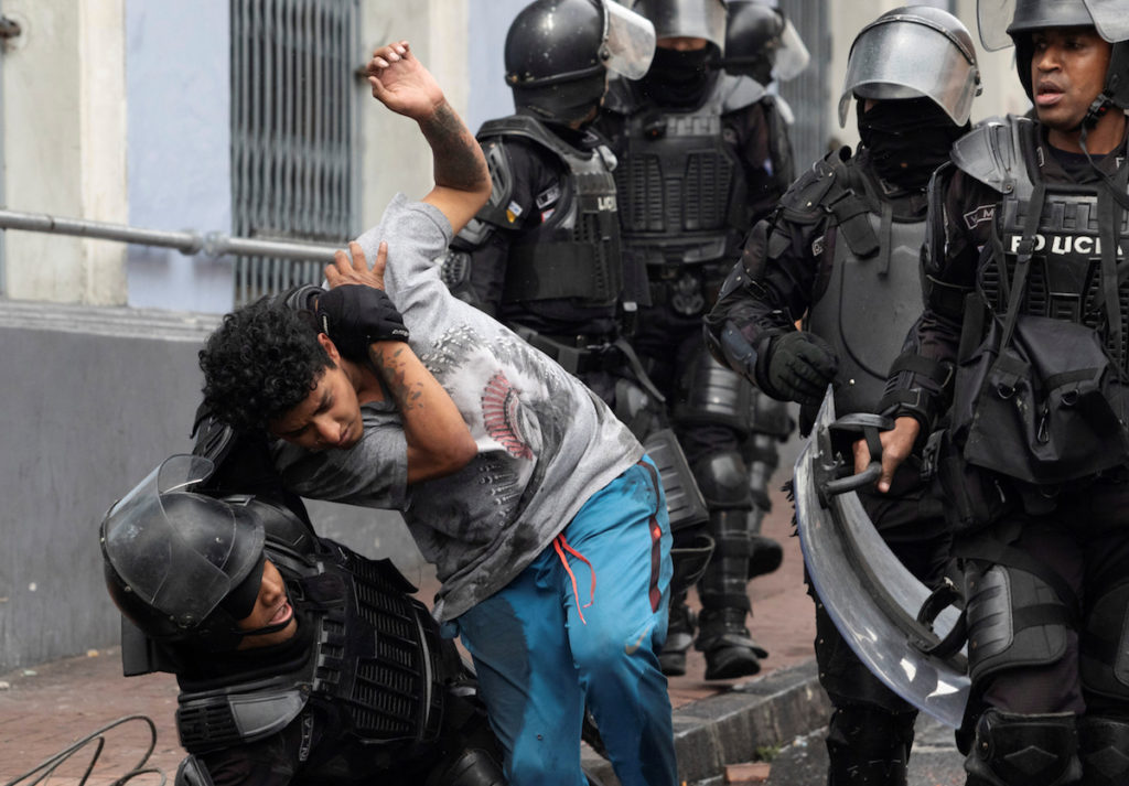 Riot police detain a man during protests after Ecuador’s President Lenin Moreno’s government ended four-decade-old fuel subsidies, in Quito