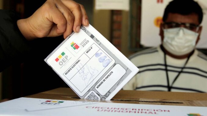 A man casts his vote during a voting simulation at a polling station in La Paz